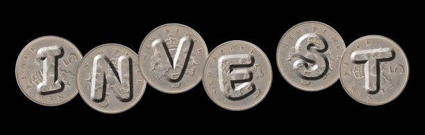 istock INVEST – Coins on black background 690047480