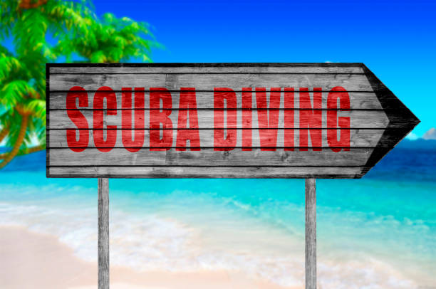 istock Red Scuba Diving wooden sign with a beach 690047554