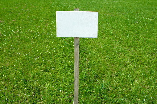 Sign on grass whith isolated space for caption