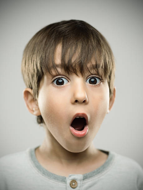 Surprised little boy with mouth open stock photo