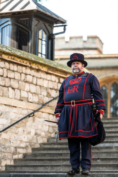 yeoman warder (beefeater) in everyday undress uniform in tower of london - local landmark international landmark middle ages tower of london imagens e fotografias de stock