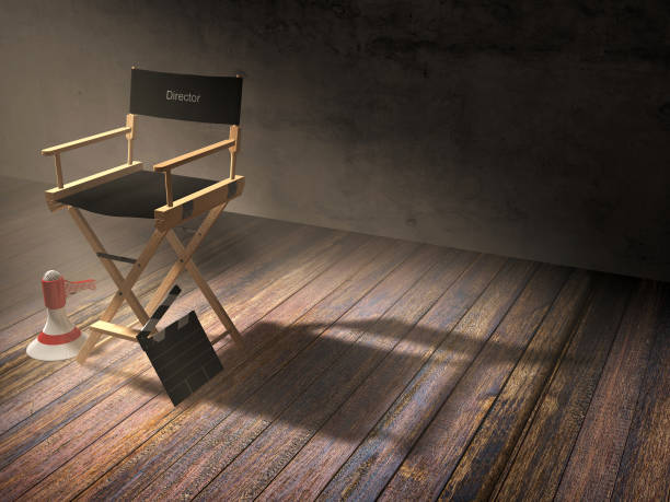 istock Director's chair with clapper board and megaphone in dark room 690053908
