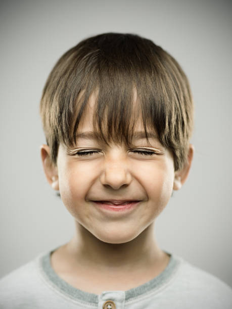 istock Cute little boy closing eyes and smiling 690053950