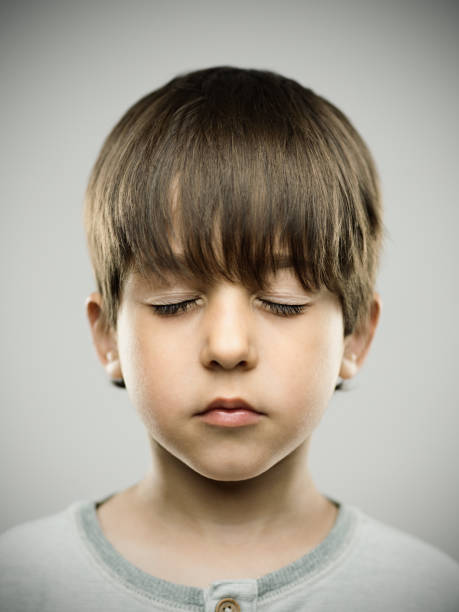 Real kid with eyes closed stock photo