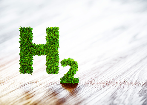 Green hydrogen element sign on blurred wooden background. 3D illustration.