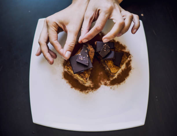 istock Hand decorated with women's beautiful chocolate cake closeup 690054162