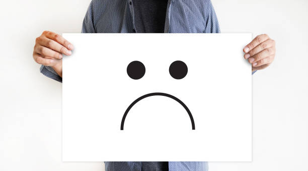 istock Depressive emotions concept,   smiley face emoticon printed. 690054230