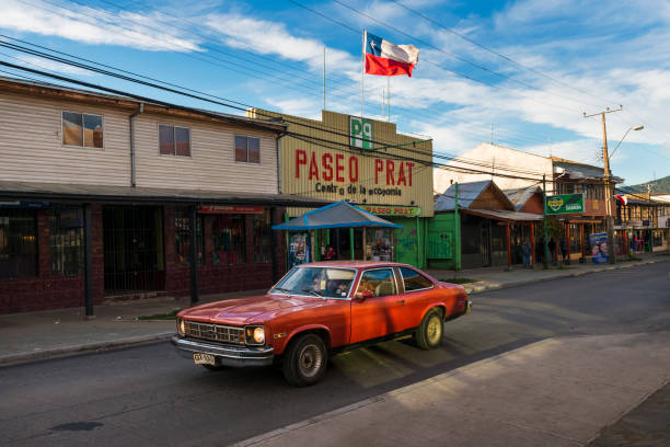 A red car in a street of the town of Coyhaique in Chile, South America Coyhaique, Chile - November 1, 2013: A red car in a street of the town of Coyhaique in Chile, South America carretera austral chile stock pictures, royalty-free photos & images