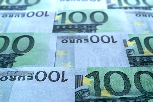 Top view of mixed euro currency banknotes in a row with focus on the numbers