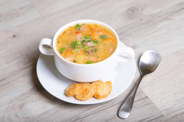 istock Pea soup with meat, smoked sausage and crackers 690065422