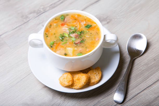 istock Pea soup with meat, smoked sausage and crackers 690065476