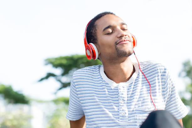 istock Relaxed young man loving music enjoying nature 690066796