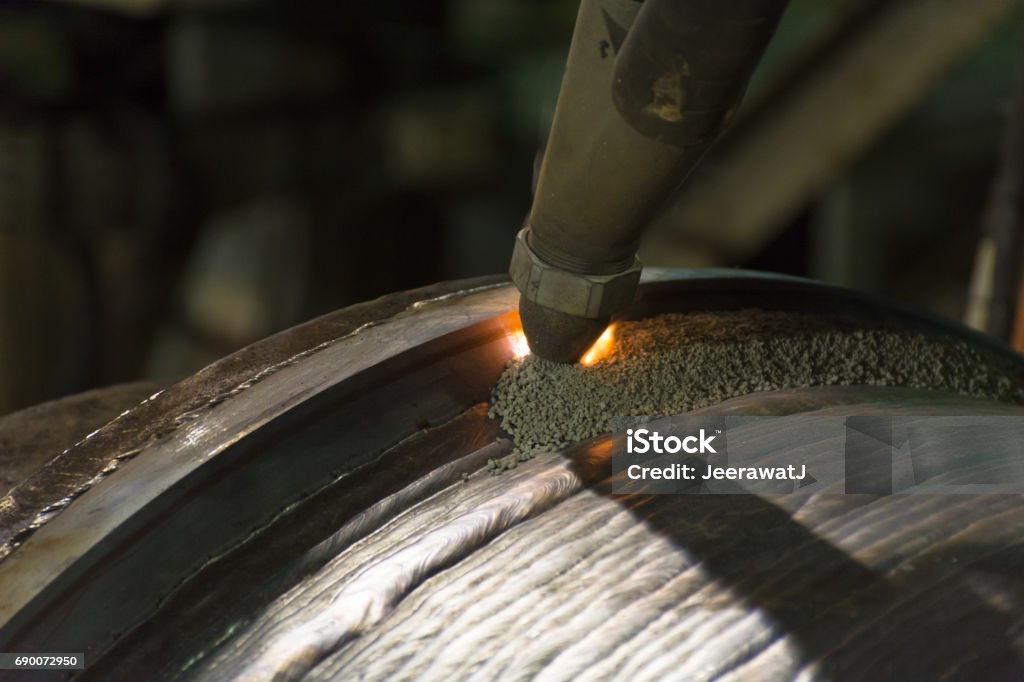 Overlay welding hard surfacing of steel roll by submerge arc welding process Underwater Stock Photo Overlay welding hard surfacing of steel roll by submerge arc welding process Underwater Stock Photo