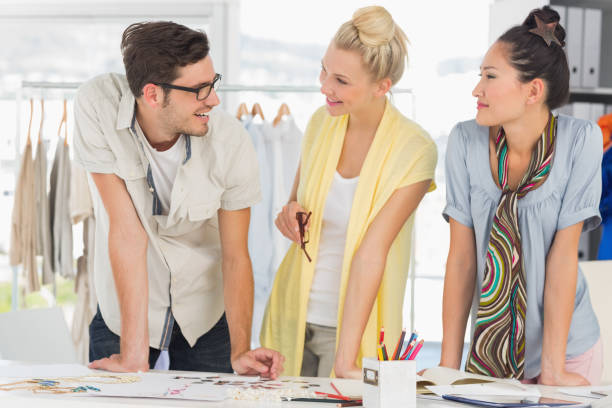 istock Fashion designers discussing designs 690087494