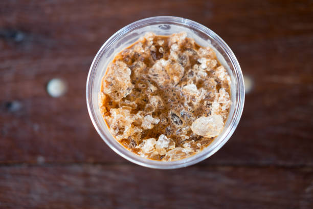 istock Close up top view cold coffee drink with ice on old wood table 690091278