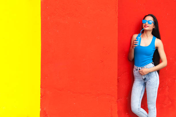 istock Young woman and colourful  wall 690092250