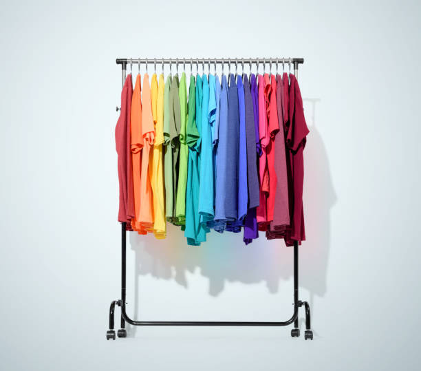 istock Mobile rack with color clothes on light blue background 690106394