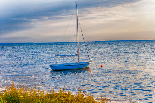 Sailboat at sunset moored on the beach
