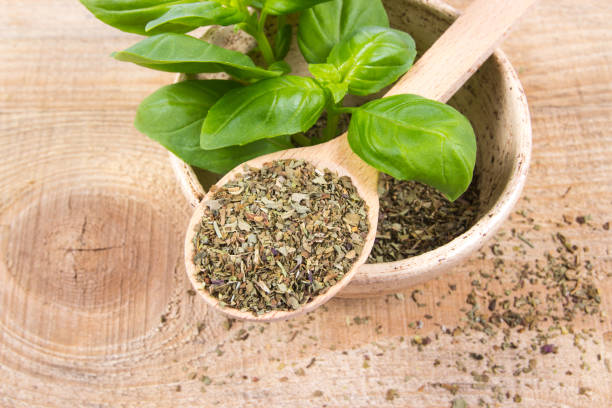 istock Raw green basil and dried, on the wooden table. 690106714