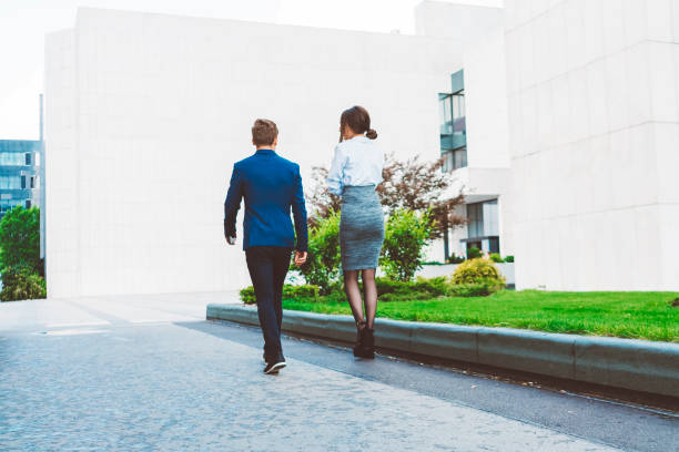 istock Two Business Colleagues Having Discussion Whilst Walking Outside 690110356