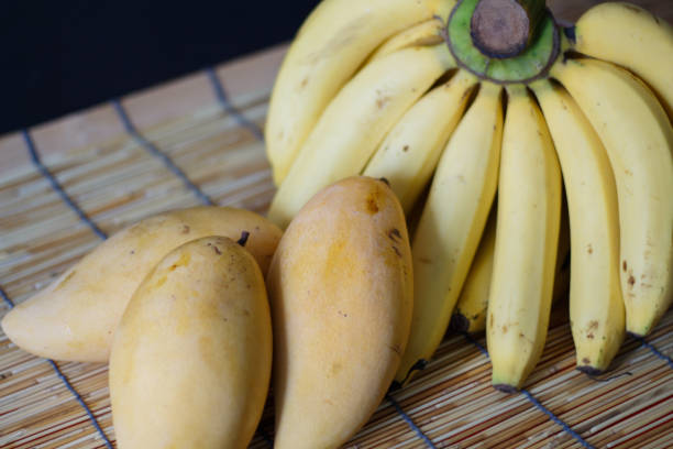 istock Raw Organic Bunch of Bananas and Mango fruit 690114860