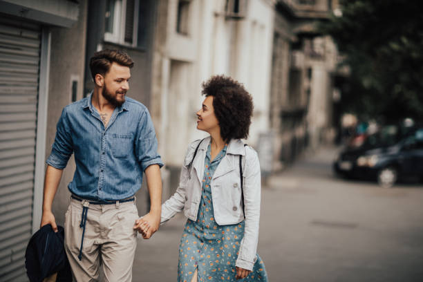 istock Couple strolling the street and holding hands 690115342