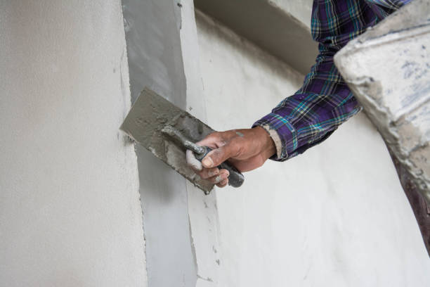 istock plasterer concrete worker at wall of house construction 690116014