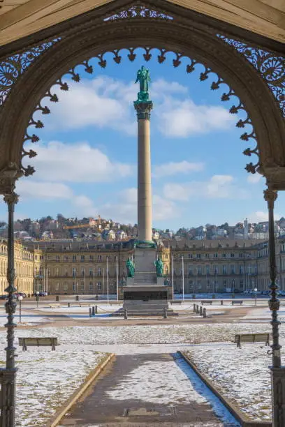 Stuttgart's central city with its square called Schlossplatz surrounded by many shops, historic buildings and gardens that are travel destinations. The  entire plaza has been a public property since 1918. During the 18th and 19th century the place was used as military ground closed to the public.  Later, from the XX century it became a public square.  After the construction of underground transportation no traffic streets pass through it. Framed in the image is the Jubilee Column with La Concordia Goddess on top. In the backround, the New Castle houses goverment offices of the Baden-Wurttemberg State.