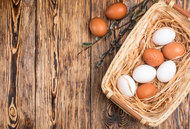 istock White and brown eggs in the basket on the table. Easter 690126472