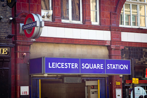 Entrance and sign for Leicester Square underground station in London, UK.  This is the main entertainment district of London.
