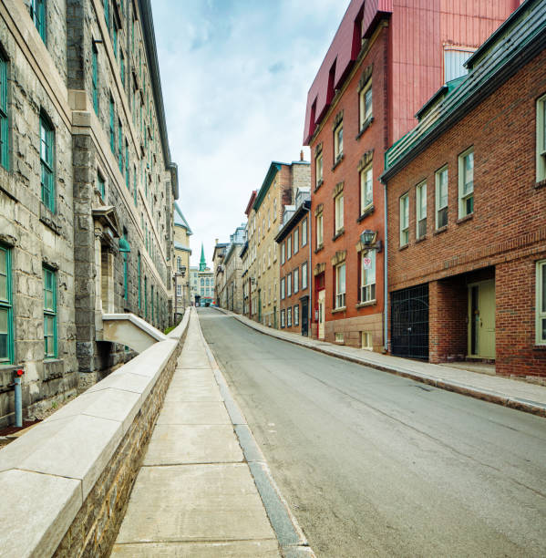 istock Empty street going uphill in old Quebec City with brick and stone buildings 690131652