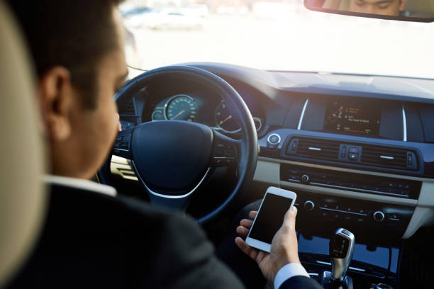 istock Businessman in a car using phone 690133874