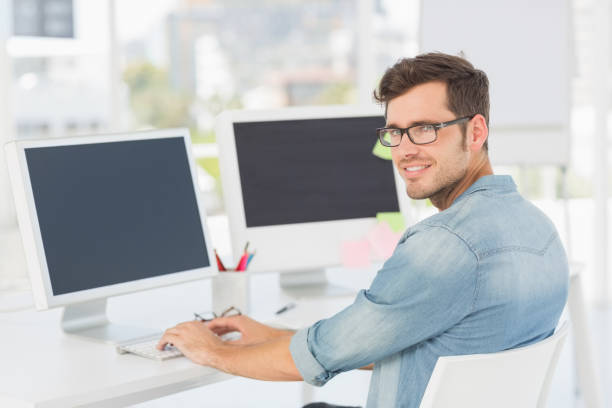 istock Side view portrait of a male artist using computer 690134136