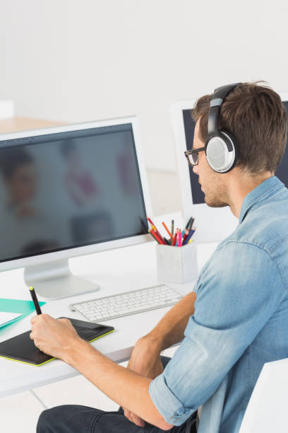 istock Casual male photo editor using graphics tablet 690134788