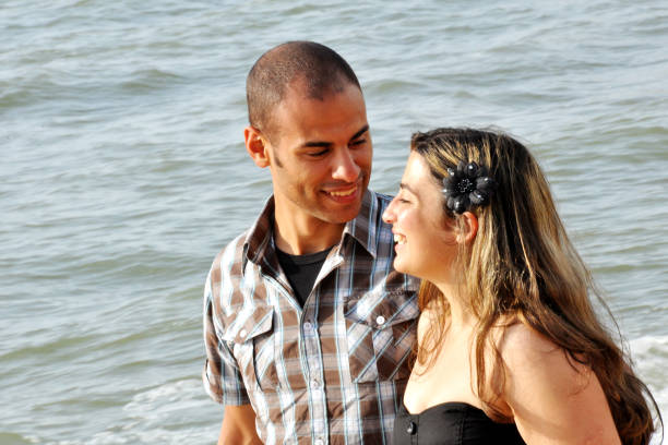 Interracial couple in love walking on the beach