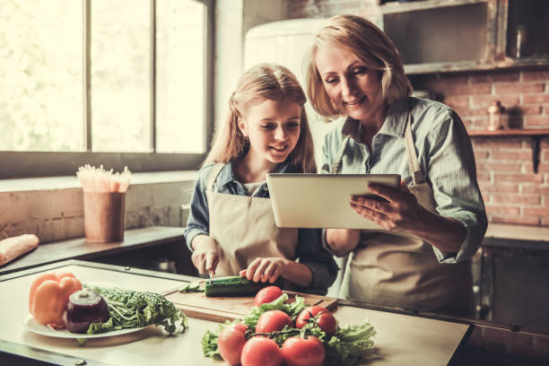 istock Grandma and granddaughter in kitchen 690138038