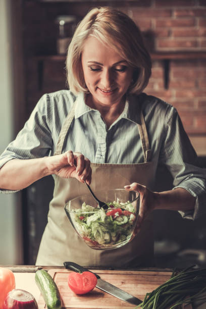 istock Mature woman in kitchen 690141160