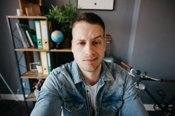 istock Cute man making a funny face and taking a selfie 690144164