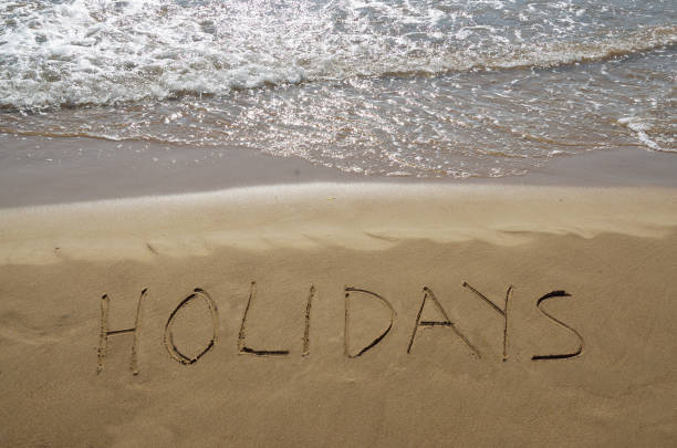 istock Word holidays written in the sand 690144642