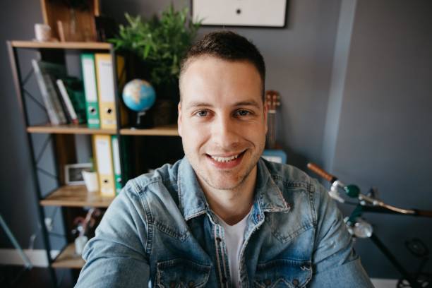 istock Beautiful smiling man taking a selfie 690144718