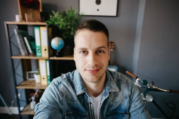 istock Beautiful young man taking selfie in his office 690145210
