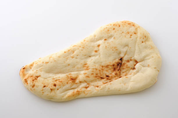naan indian bread isolated on white background naan indian bread isolated on white background pita bread isolated stock pictures, royalty-free photos & images