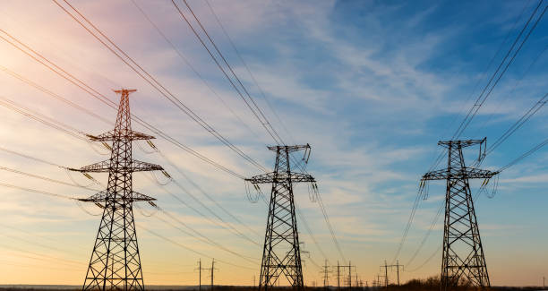 istock Electrical power lines as sun sets in background 690153116