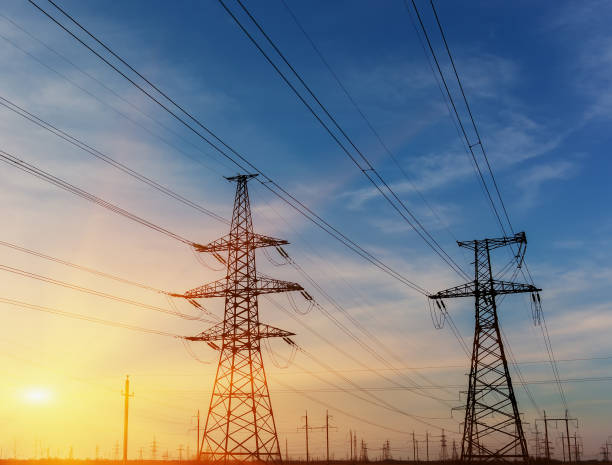 istock High power electricity transmission pylon silhouette. 690153144