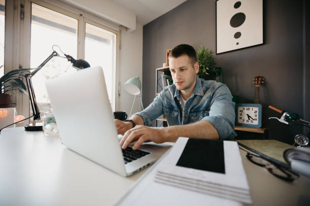 istock Handsome interior designer working on the laptop in the office 690153358