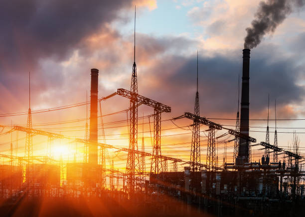 Power station at dusk and power lines Power station at dusk and power lines. terminal tower stock pictures, royalty-free photos & images