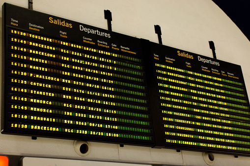 Airport electronic flight arrival and departure information board at Seville International airport.