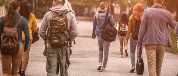 istock Group of sudents walking through the park 690166500
