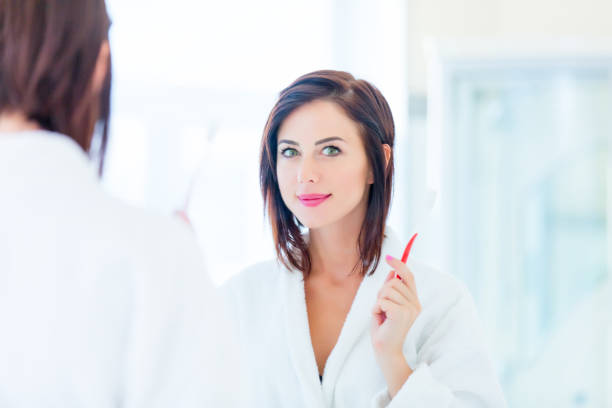 istock young woman with toothbrush 690169902