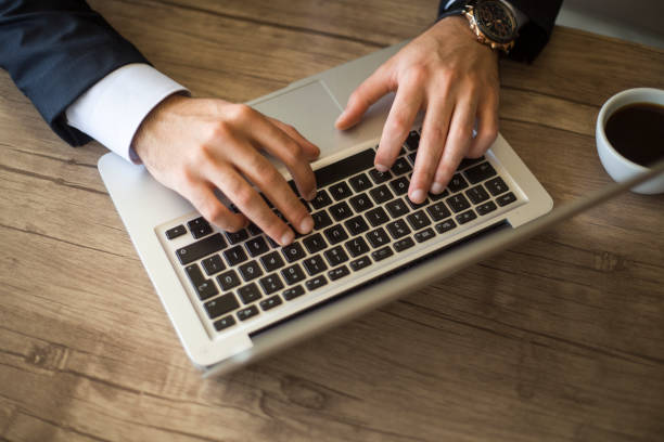 Typing on laptop close-up